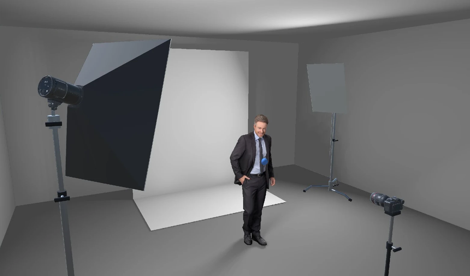 A high-key portrait setup: large softbox with a flash head, white paper backdrop, a bounce board and camera, with the subject in a suit
